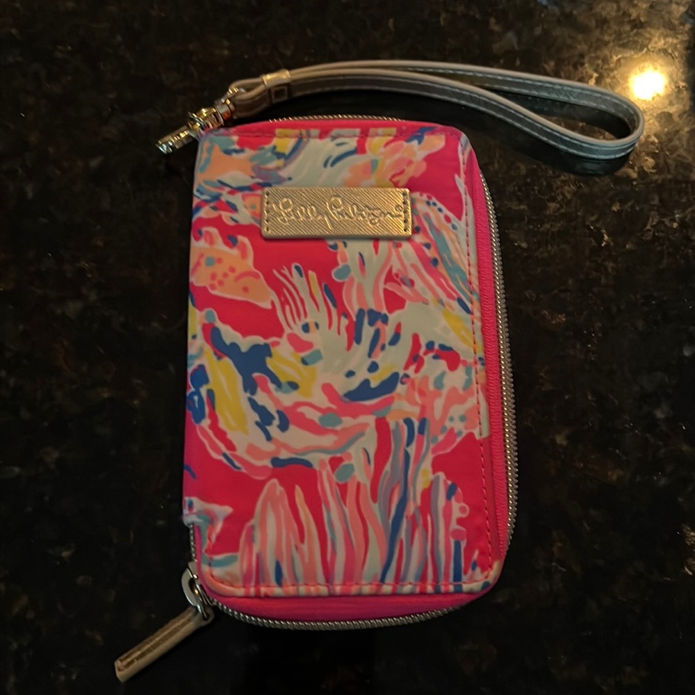 Fun Lilly wallet. Has ID and card holder as well as on the other side. NWOT.